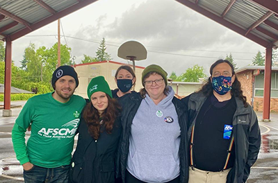CJ Alicandro (left) is pictured with a few of their colleagues. Photo credit: AFSCME Council 75.